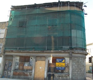 Shrouded in scaffolding, the building is almost falling down