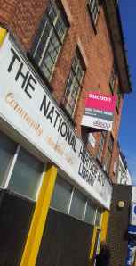 A for-sale-by-auction sign went up on the building on June 30th.